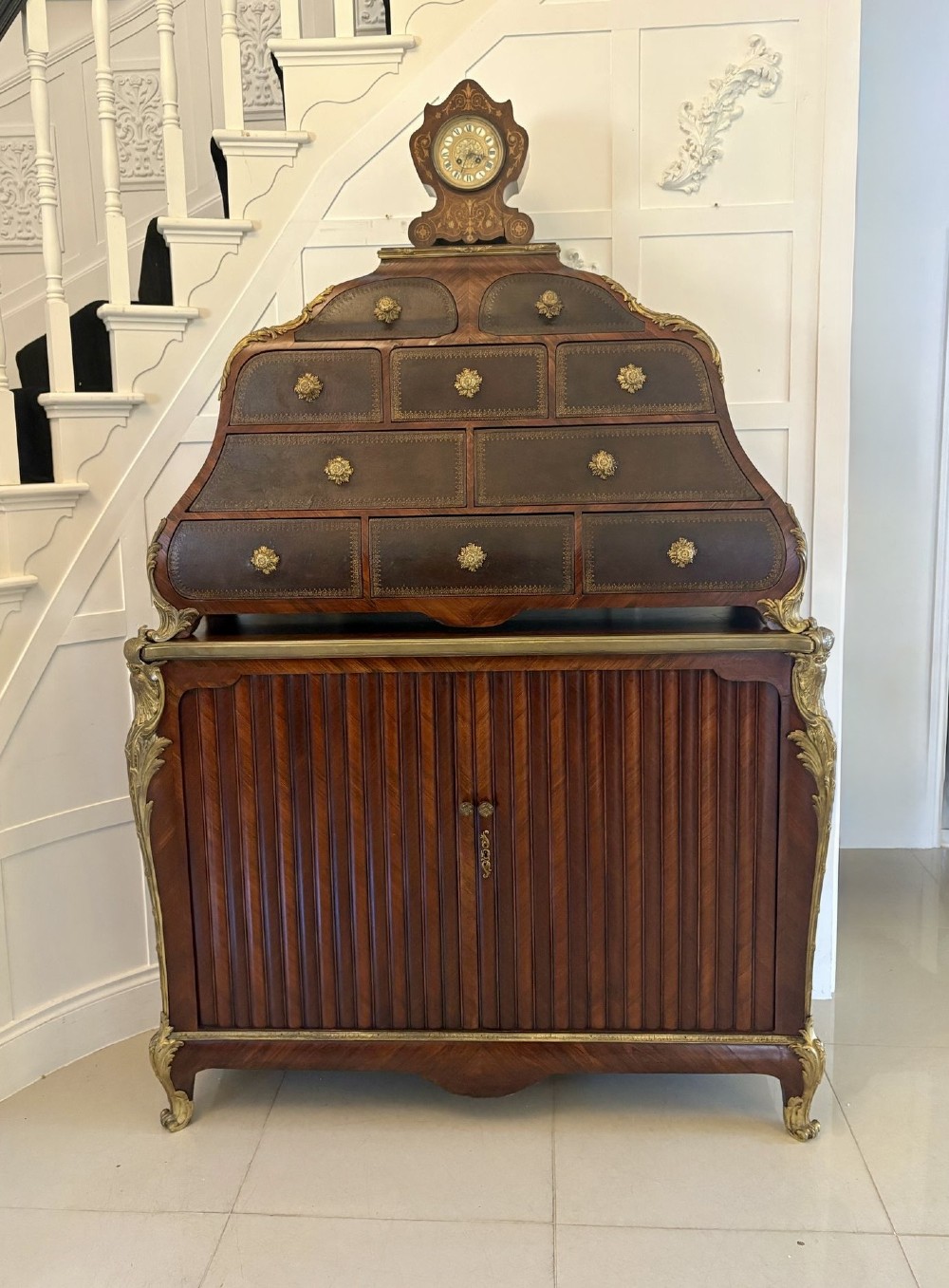 A nineteenth-century French kingwood cartonnier cabinet with leather-faced document drawers and gilded bronze mounts above a fluted cupboard base. View VI