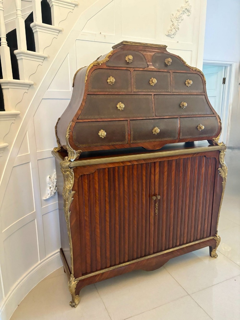 A nineteenth-century French kingwood cartonnier cabinet with leather-faced document drawers and gilded bronze mounts above a fluted cupboard base. View VIII