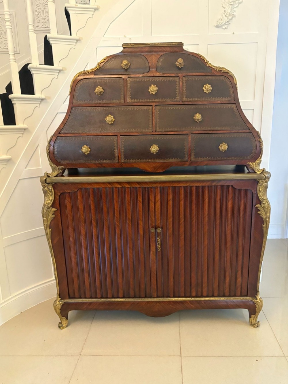 A nineteenth-century French kingwood cartonnier cabinet with leather-faced document drawers and gilded bronze mounts above a fluted cupboard base. View IX