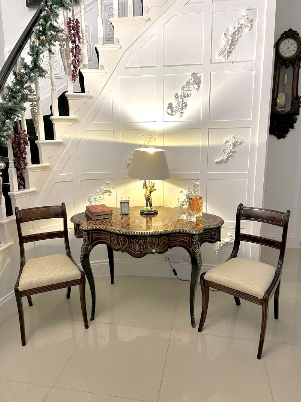 An antique French Rococo Revival centre table featuring detailed marquetry and parquetry wood patterns, serpentine edges, brass ormolu mounts, and curved cabriole legs. View V