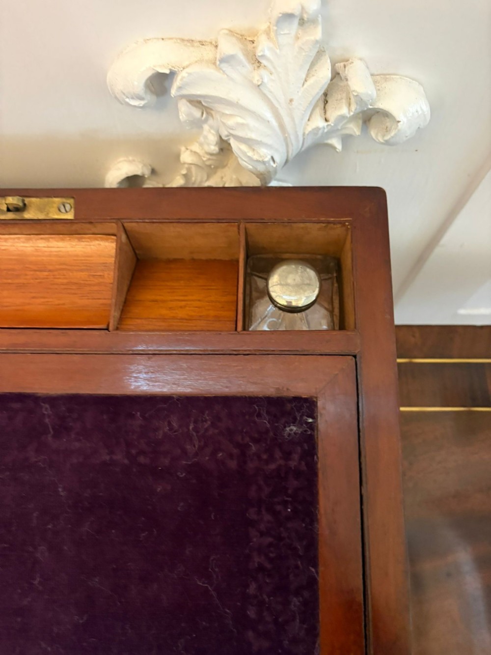 A rectangular Victorian mahogany writing box featuring brass corner brackets, vertical brass strapping, a central brass shield inlay, and a brass keyhole escutcheon. View VIII