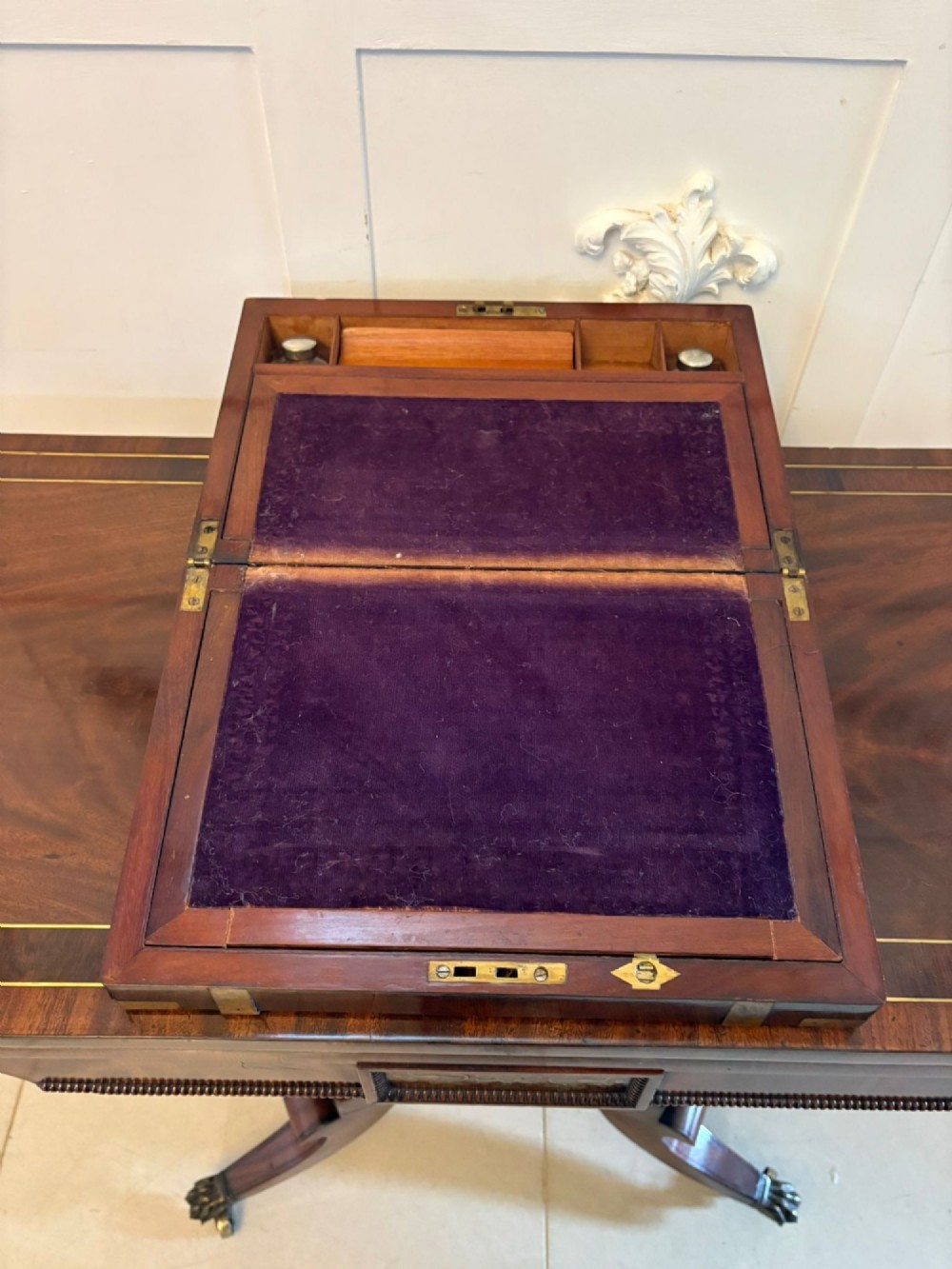 A rectangular Victorian mahogany writing box featuring brass corner brackets, vertical brass strapping, a central brass shield inlay, and a brass keyhole escutcheon. View IX