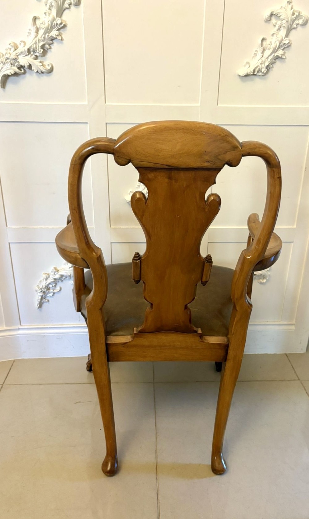 A pair of carved walnut desk armchairs featuring vasiform splats, green leather seats with brass studding, and cabriole legs ending in ball and claw feet. View II