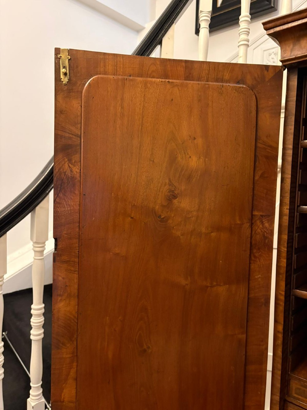 An 18th-century George I figured walnut bureau bookcase featuring two mirrored upper cabinet doors, a slant-front writing desk, and three lower drawers on bracket feet. View VIII