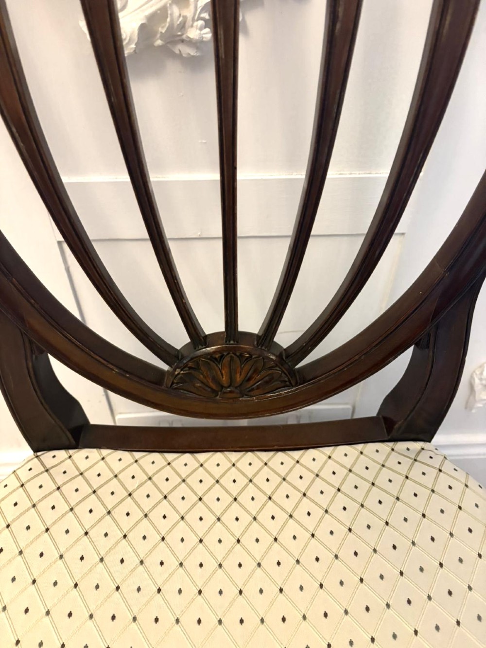 A set of ten Edwardian mahogany shield-back dining chairs with cream geometric upholstered seats, including two carvers with curved arms. View XI