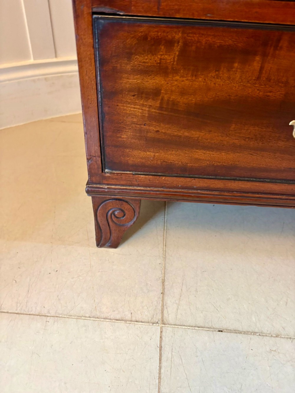 A tall Regency mahogany secretaire bookcase featuring two upper glazed doors with curved glazing bars above a chest of drawers with ornate brass handles. View XII