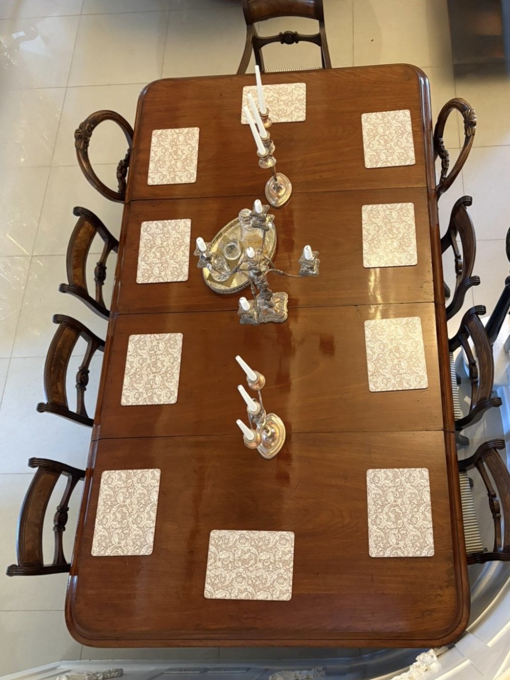 A large Victorian mahogany extending dining table with a polished surface, moulded rim, additional leaves, and turned fluted legs on brass castors. View VIII