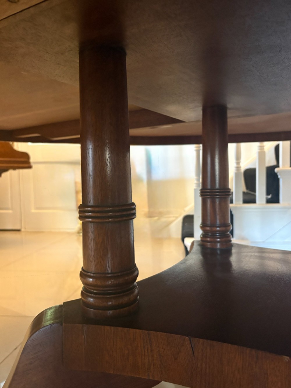 A large circular mahogany dining table featuring a yew wood crossbanded border and a central pedestal base. View VI