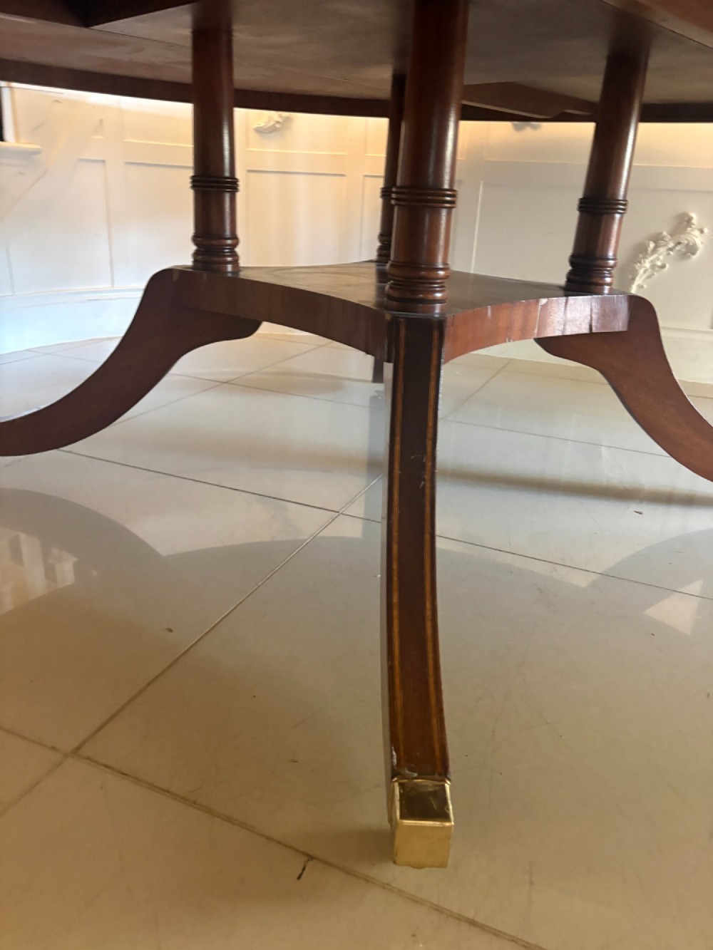 A large circular mahogany dining table featuring a yew wood crossbanded border and a central pedestal base. View VIII