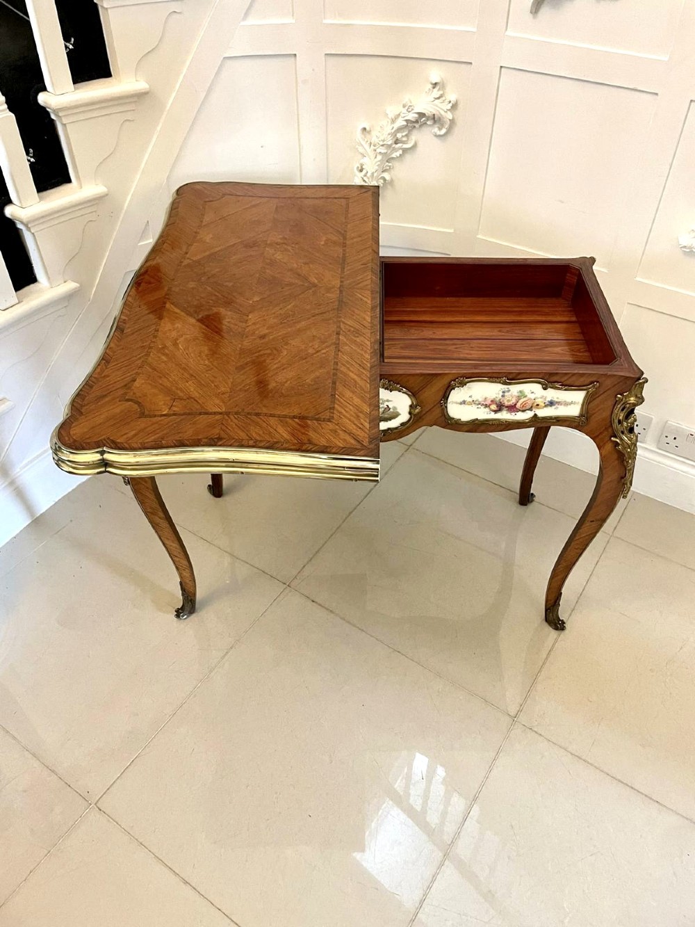 A Victorian Louis XV Revival kingwood console card table featuring a serpentine fold-over top, cabriole legs, gilt bronze mounts, and inset painted porcelain plaques. View VIII