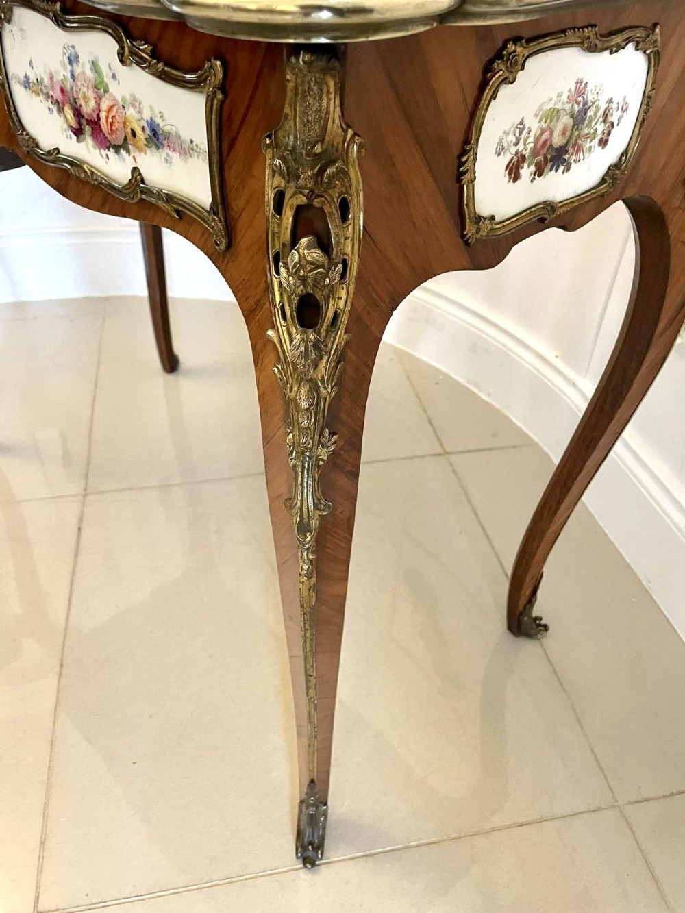 A Victorian Louis XV Revival kingwood console card table featuring a serpentine fold-over top, cabriole legs, gilt bronze mounts, and inset painted porcelain plaques. View X