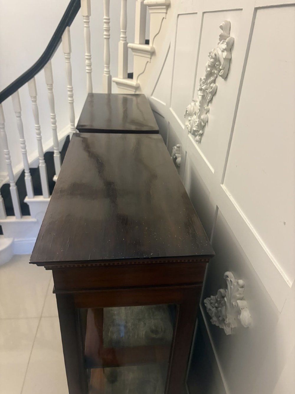 A pair of tall Edwardian mahogany display cabinets with geometric astragal glazed glass doors and slender cabriole legs. View VII