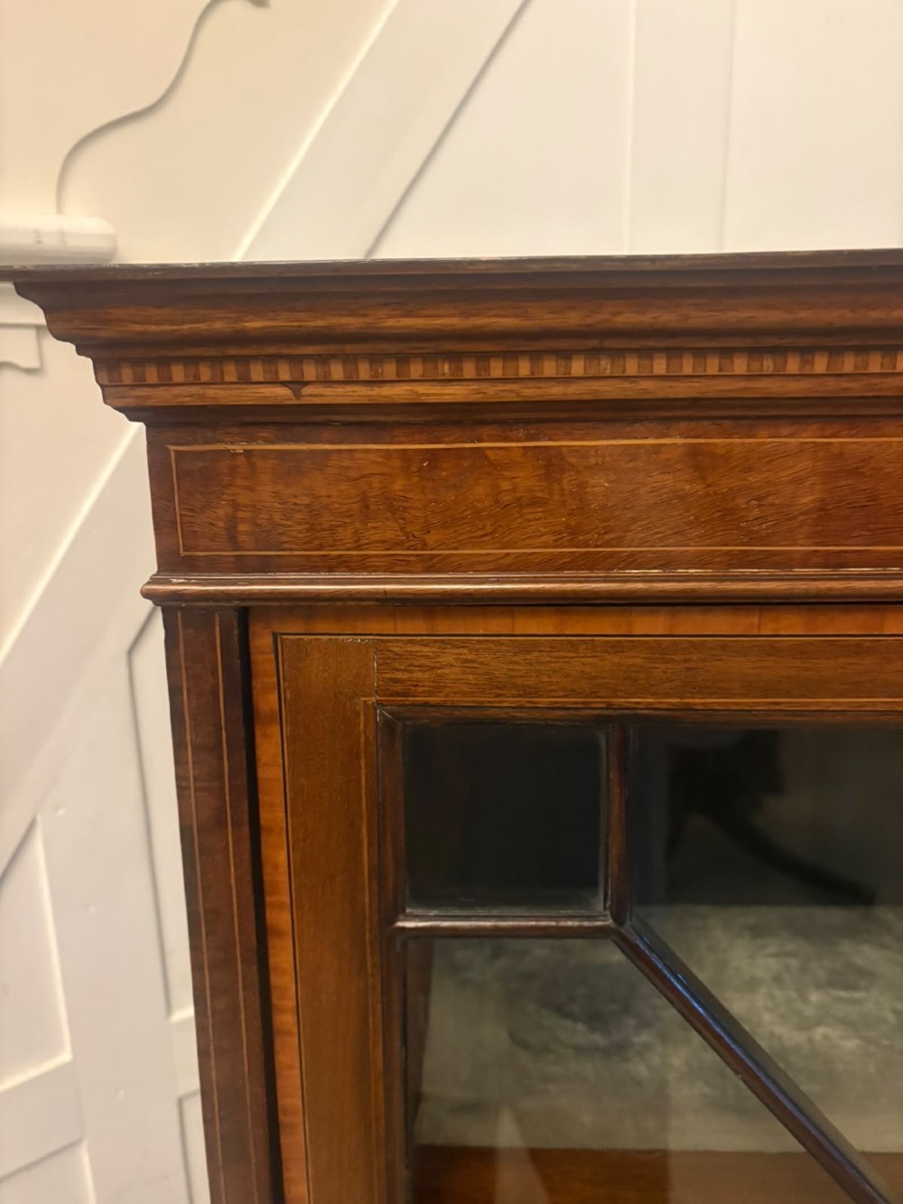 A pair of tall Edwardian mahogany display cabinets with geometric astragal glazed glass doors and slender cabriole legs. View XI