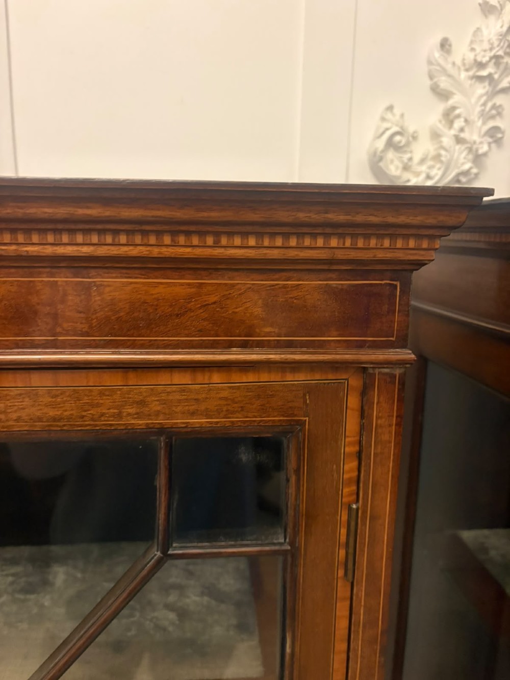 A pair of tall Edwardian mahogany display cabinets with geometric astragal glazed glass doors and slender cabriole legs. View XII