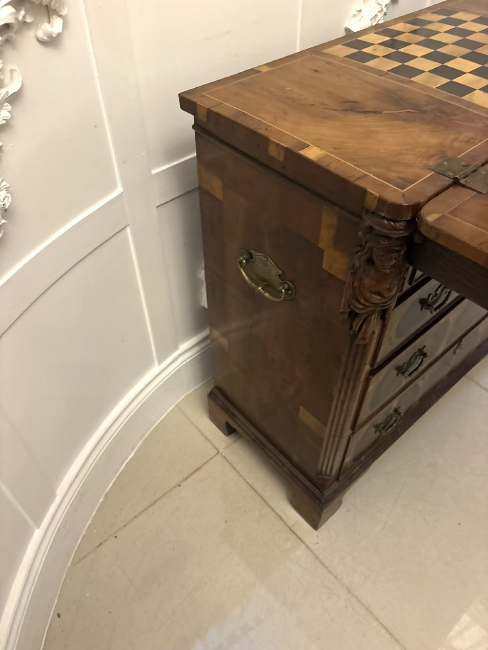A George I yew wood and laburnum oyster veneered bachelors chest of drawers with carved corner caryatids and brass drop handles. View IV