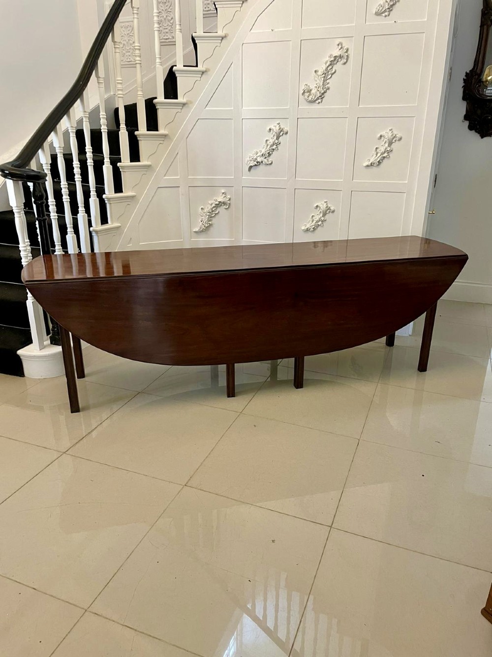 A large Georgian mahogany wake table shown with drop leaves folded down, featuring straight square legs and a polished polished timber top. View XIV