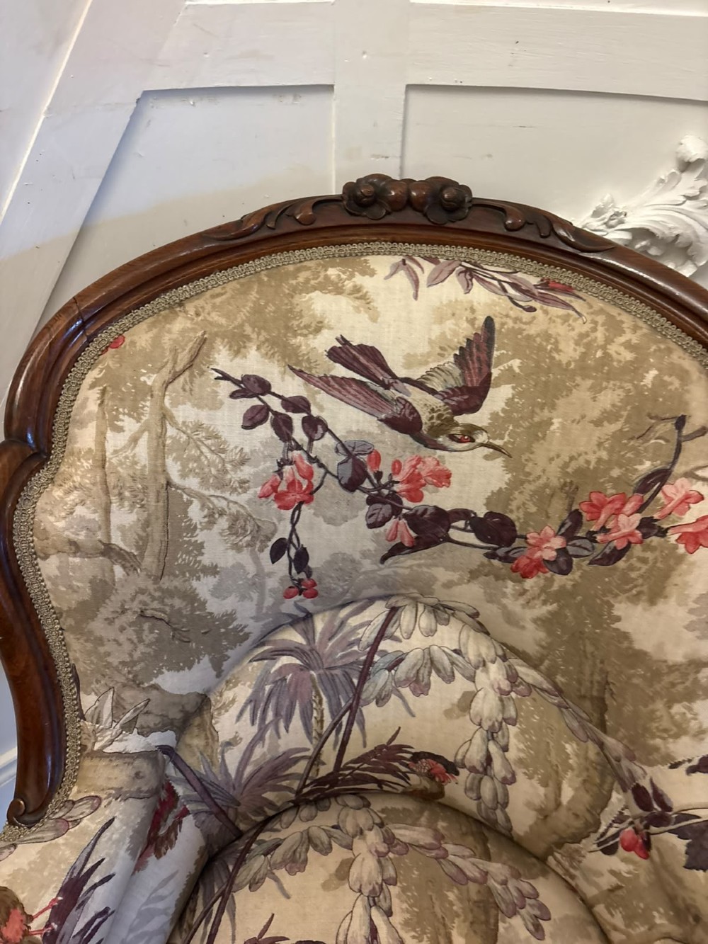 An antique Victorian carved rosewood armchair featuring floral and bird pattern upholstery with cabriole legs on castors. View IX