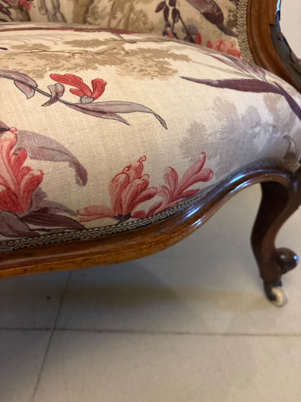 An antique Victorian carved rosewood armchair featuring floral and bird pattern upholstery with cabriole legs on castors. View X