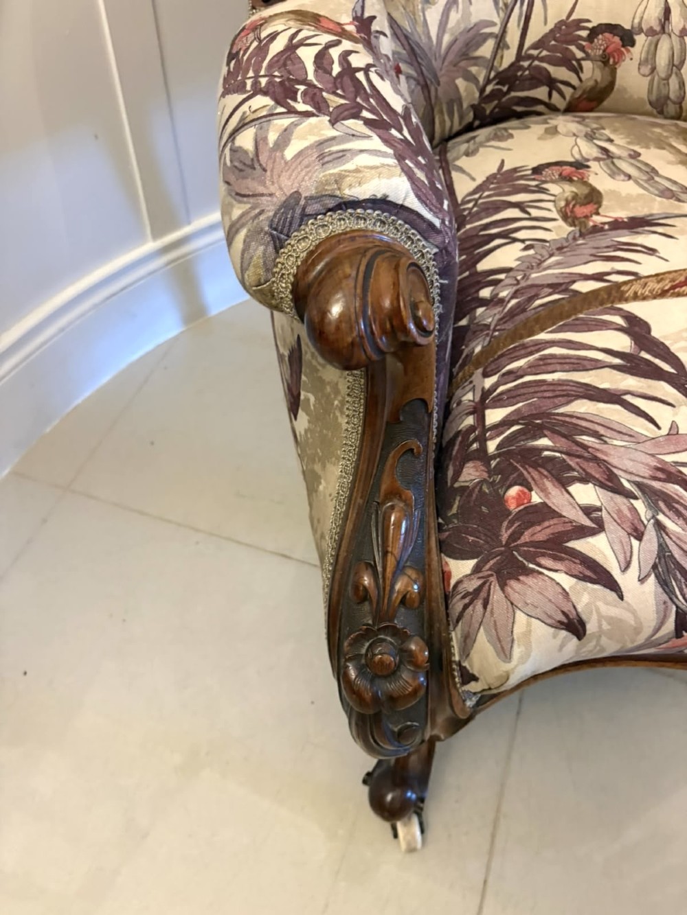 An antique Victorian carved rosewood armchair featuring floral and bird pattern upholstery with cabriole legs on castors. View XI