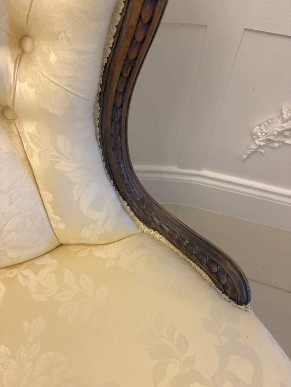 A Victorian carved walnut slipper chair featuring a button-tufted cream damask spoon-shaped backrest and cabriole front legs. View IV