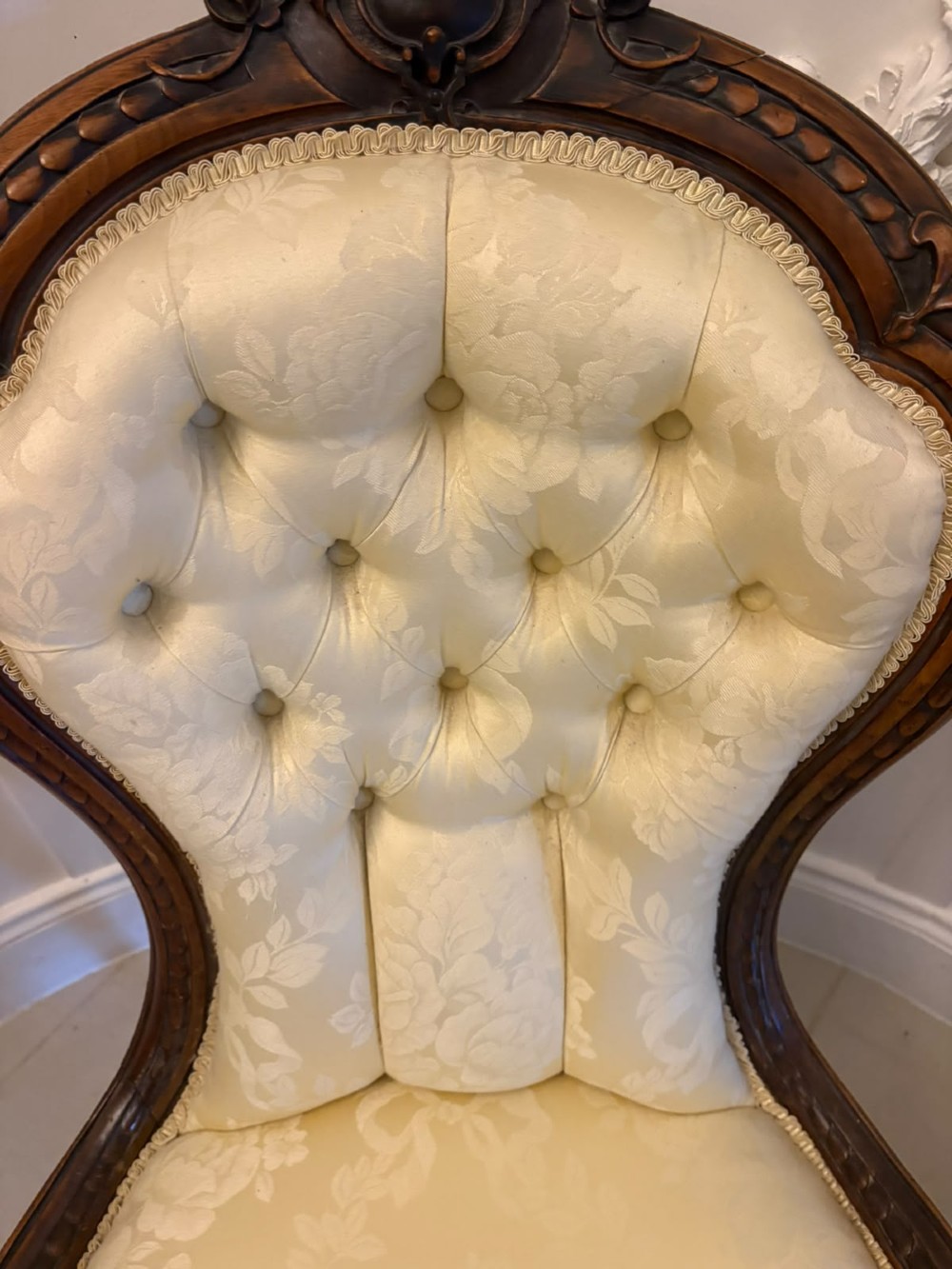 A Victorian carved walnut slipper chair featuring a button-tufted cream damask spoon-shaped backrest and cabriole front legs. View XI