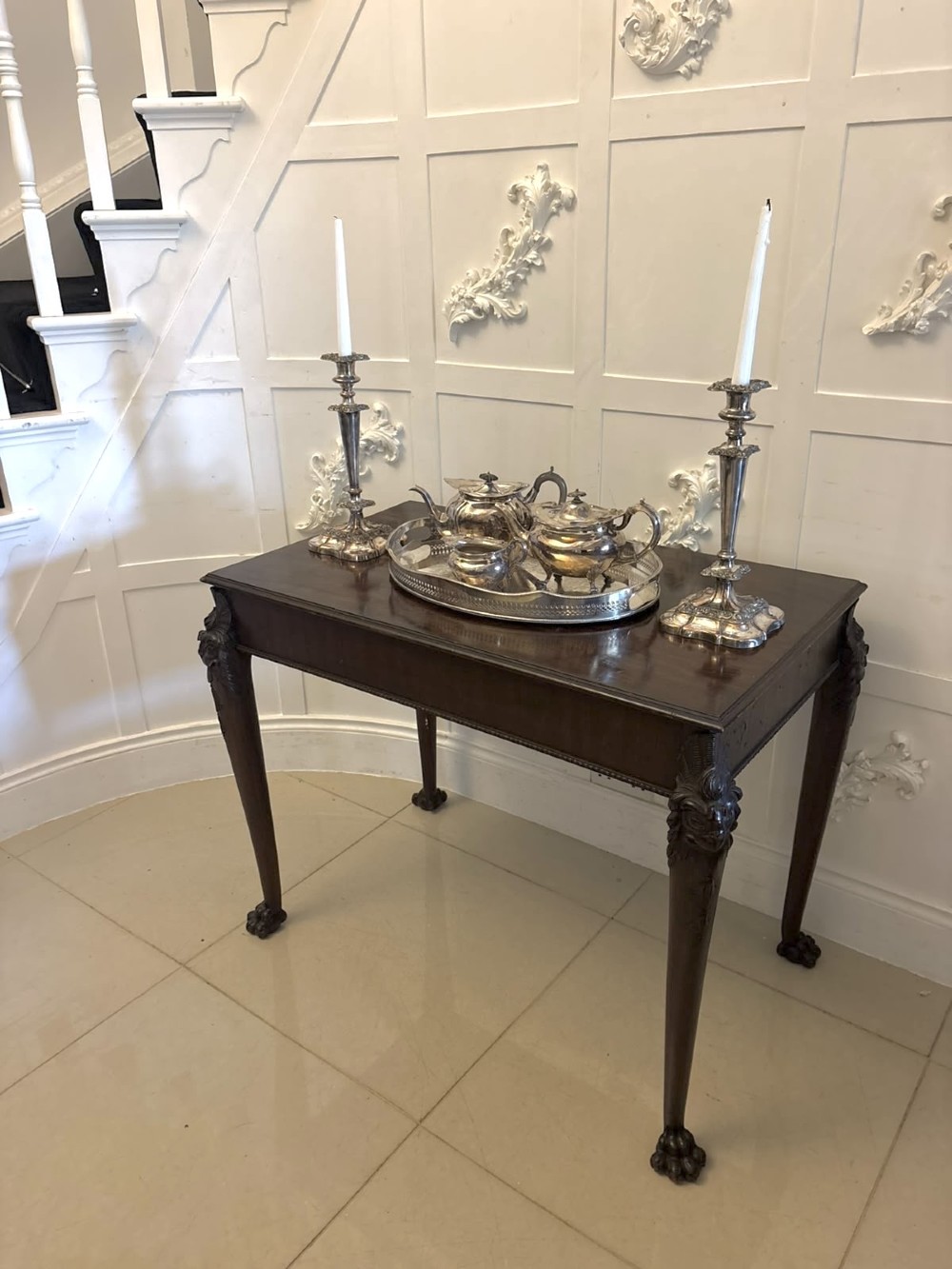 A George III mahogany centre table featuring a rectangular flat top, deep apron, and four carved legs ending in claw and ball feet. View V