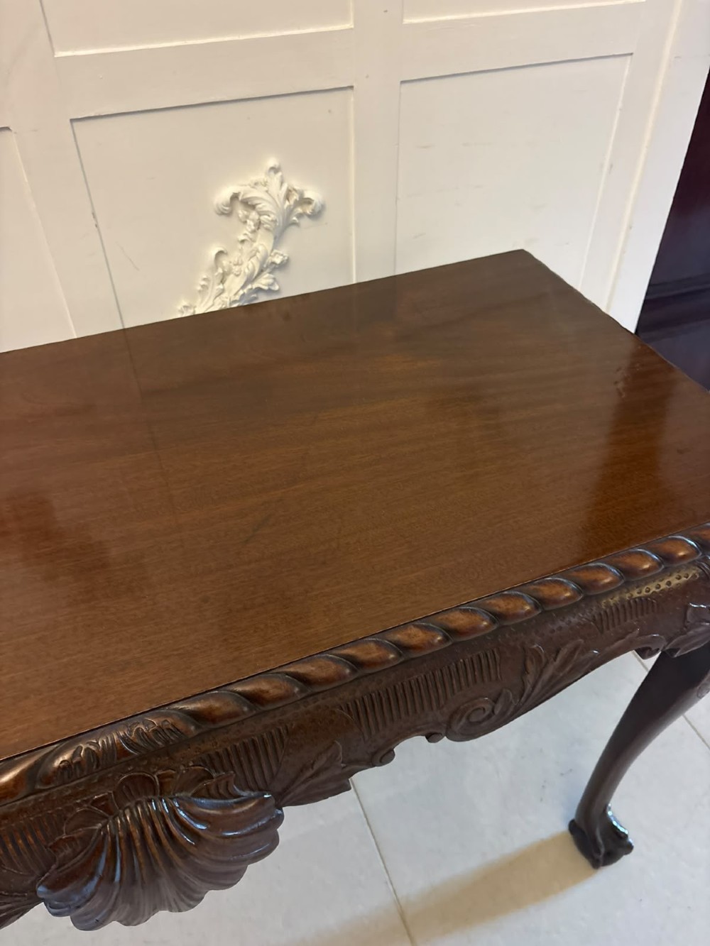 A Victorian carved mahogany console table featuring cabriole legs with ball and claw feet, a shell-carved central apron, and a gadrooned top border. View III