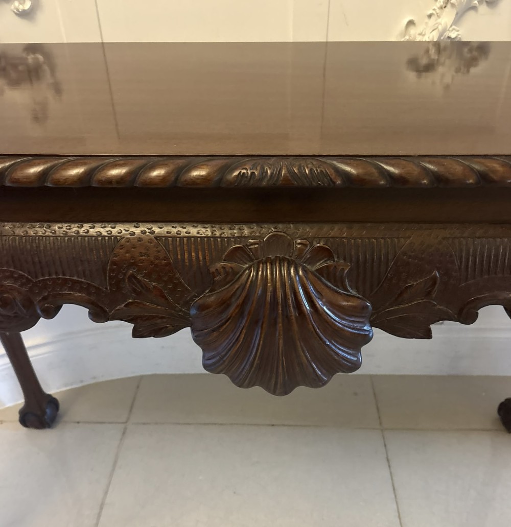 A Victorian carved mahogany console table featuring cabriole legs with ball and claw feet, a shell-carved central apron, and a gadrooned top border. View VIII