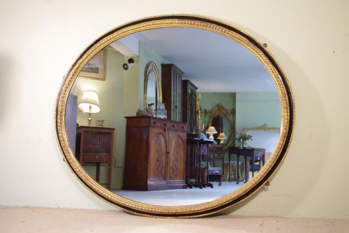 LARGE OVAL EBONISED AND PARCELGILT OVERMANTLEWALL MIRROR - ADDITIONAL PHOTO 1