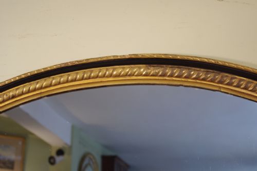 LARGE OVAL EBONISED AND PARCELGILT OVERMANTLEWALL MIRROR - ADDITIONAL PHOTO 2