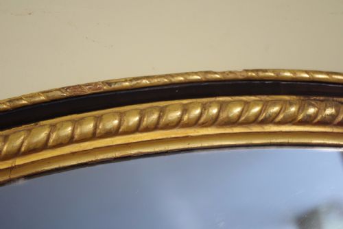 LARGE OVAL EBONISED AND PARCELGILT OVERMANTLEWALL MIRROR - ADDITIONAL PHOTO 4