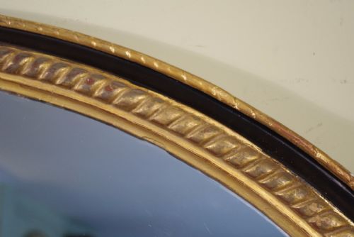 LARGE OVAL EBONISED AND PARCELGILT OVERMANTLEWALL MIRROR - ADDITIONAL PHOTO 6