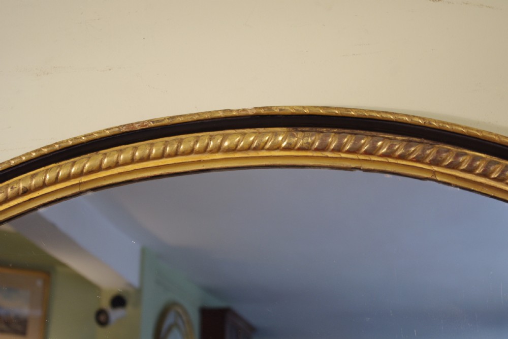 Large Oval Ebonised and Parcel-Gilt Overmantle/Wall Mirror View III