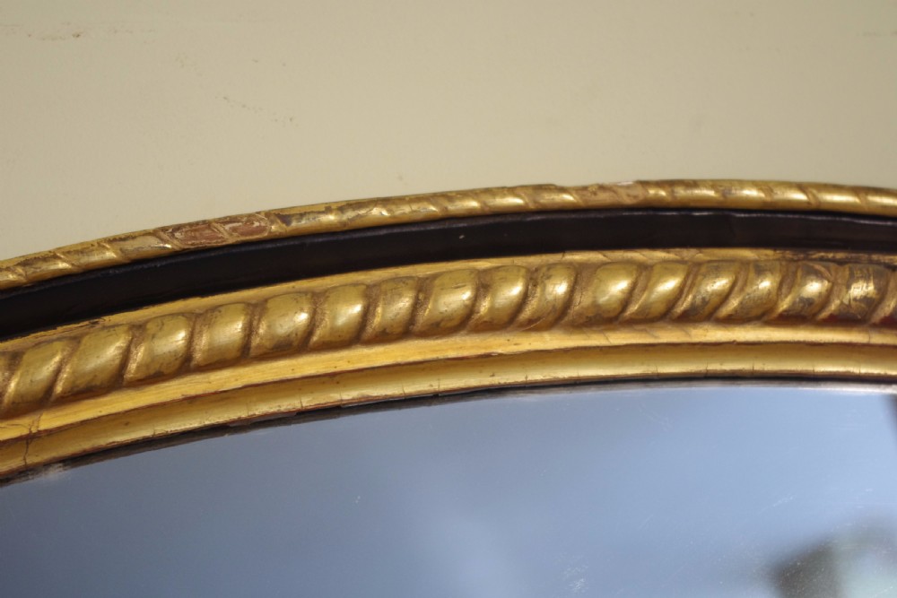 Large Oval Ebonised and Parcel-Gilt Overmantle/Wall Mirror View V