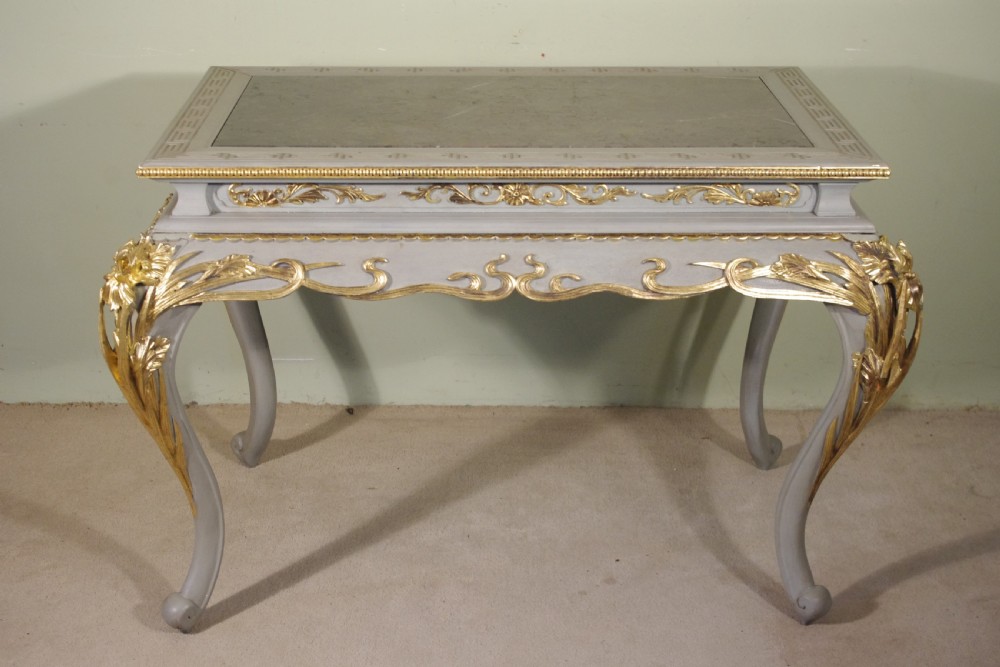 A grey painted rectangular centre table featuring ornate parcel-gilt leaf carvings on cabriole legs and an inset grey marble top. View II