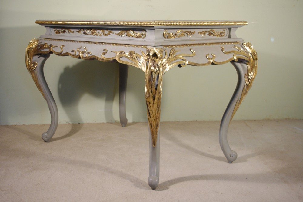 A grey painted rectangular centre table featuring ornate parcel-gilt leaf carvings on cabriole legs and an inset grey marble top. View III