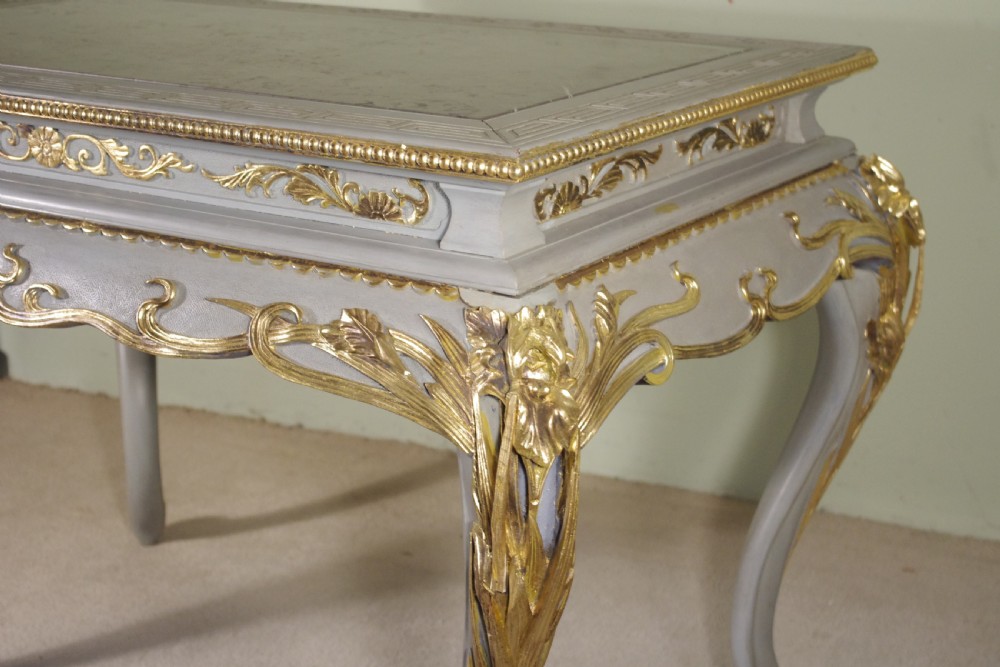 A grey painted rectangular centre table featuring ornate parcel-gilt leaf carvings on cabriole legs and an inset grey marble top. View V