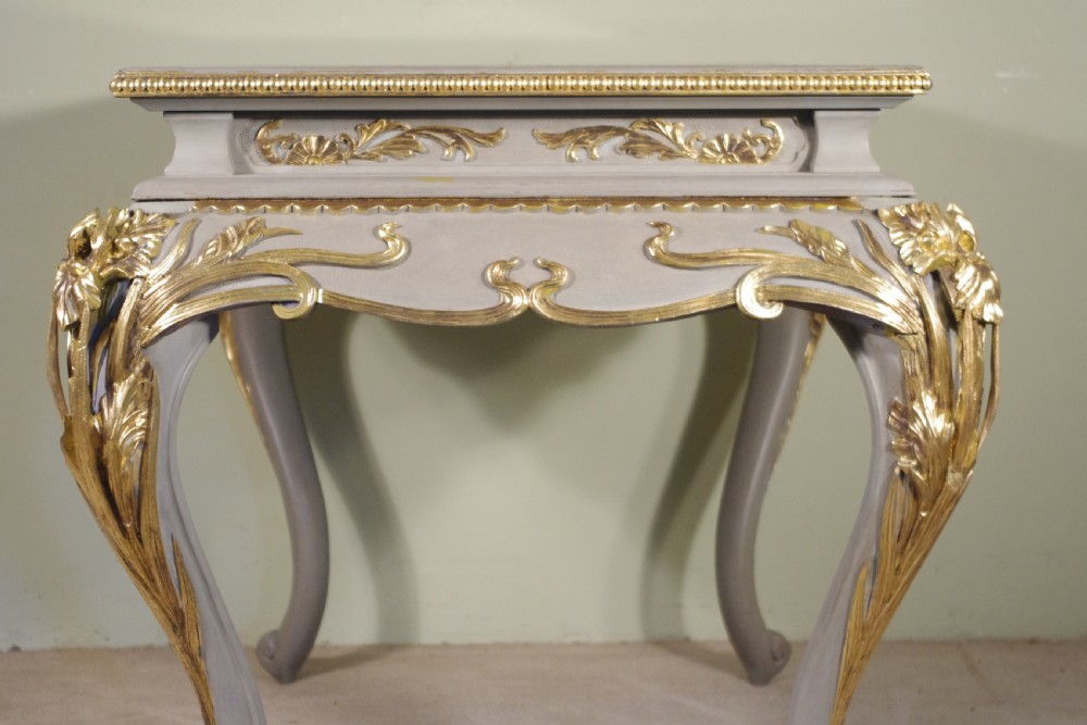 A grey painted rectangular centre table featuring ornate parcel-gilt leaf carvings on cabriole legs and an inset grey marble top. View VIII