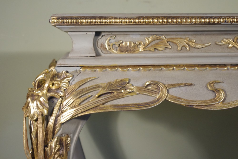 A grey painted rectangular centre table featuring ornate parcel-gilt leaf carvings on cabriole legs and an inset grey marble top. View XI
