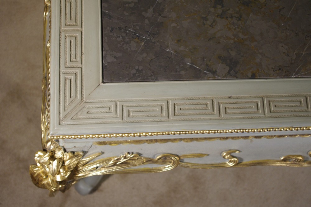 A grey painted rectangular centre table featuring ornate parcel-gilt leaf carvings on cabriole legs and an inset grey marble top. View XVI