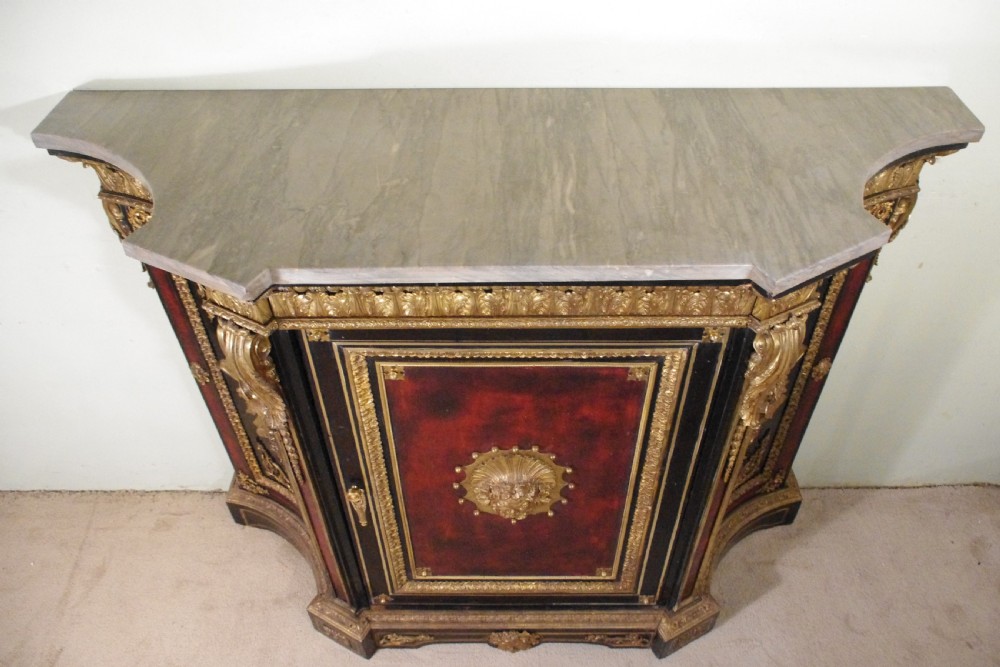 A 19th-century French ebonised side cabinet featuring gilt-metal mounts, a central red panel with a classical medallion, and a contoured marble top. View IV