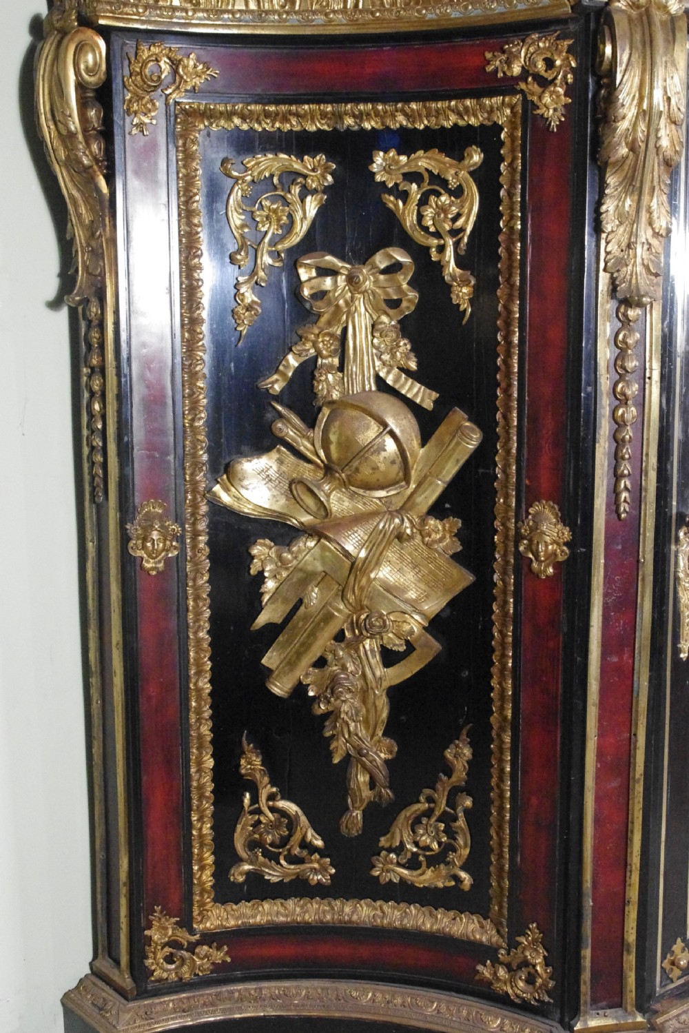 A 19th-century French ebonised side cabinet featuring gilt-metal mounts, a central red panel with a classical medallion, and a contoured marble top. View VIII