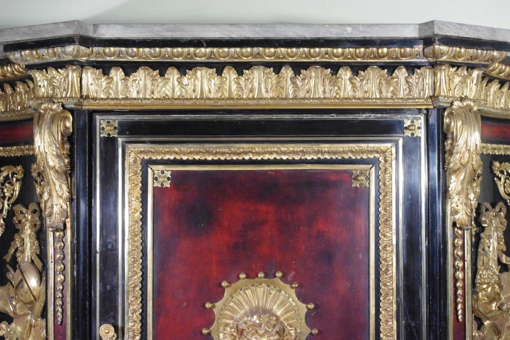 A 19th-century French ebonised side cabinet featuring gilt-metal mounts, a central red panel with a classical medallion, and a contoured marble top. View XI
