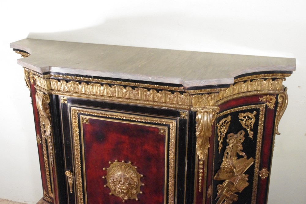 A 19th-century French ebonised side cabinet featuring gilt-metal mounts, a central red panel with a classical medallion, and a contoured marble top. View XIV