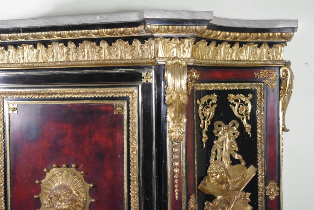 A 19th-century French ebonised side cabinet featuring gilt-metal mounts, a central red panel with a classical medallion, and a contoured marble top. View XV