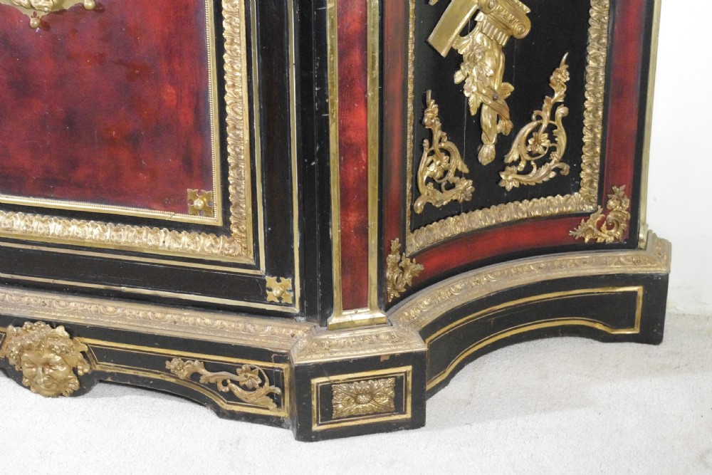 A 19th-century French ebonised side cabinet featuring gilt-metal mounts, a central red panel with a classical medallion, and a contoured marble top. View XVII