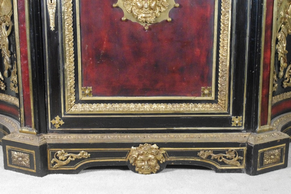 A 19th-century French ebonised side cabinet featuring gilt-metal mounts, a central red panel with a classical medallion, and a contoured marble top. View XIX