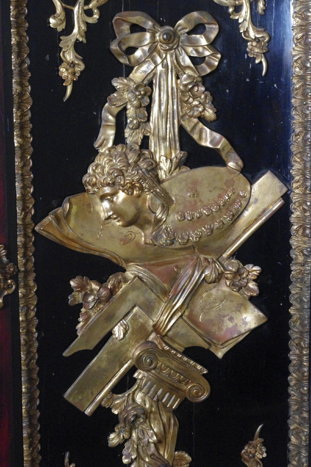 A 19th-century French ebonised side cabinet featuring gilt-metal mounts, a central red panel with a classical medallion, and a contoured marble top. View XXII