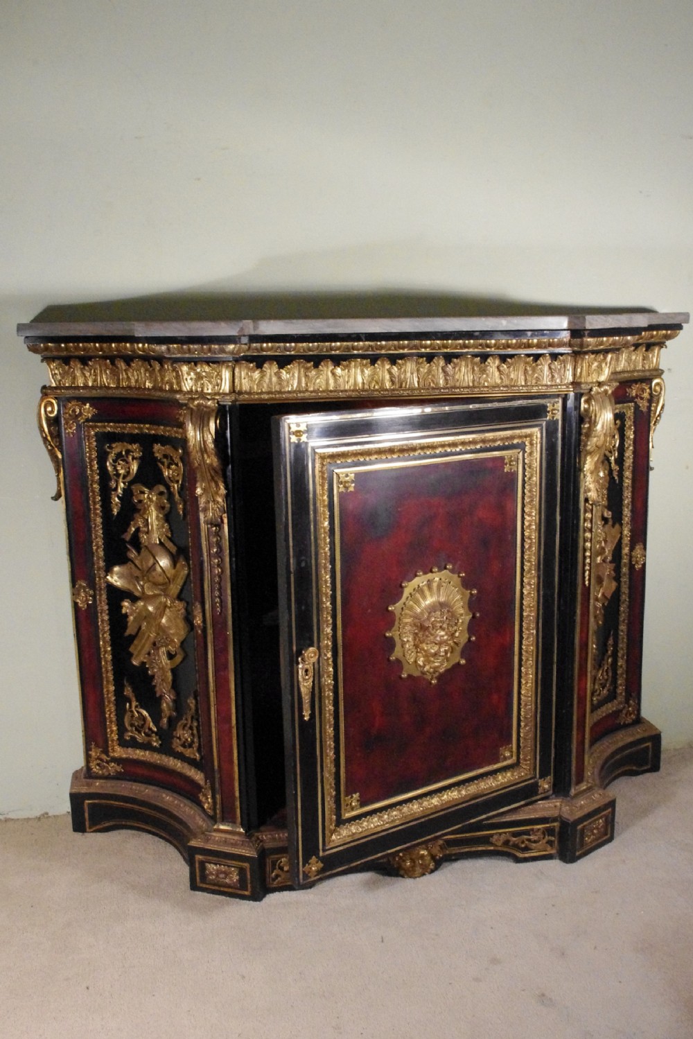 A 19th-century French ebonised side cabinet featuring gilt-metal mounts, a central red panel with a classical medallion, and a contoured marble top. View XXVI
