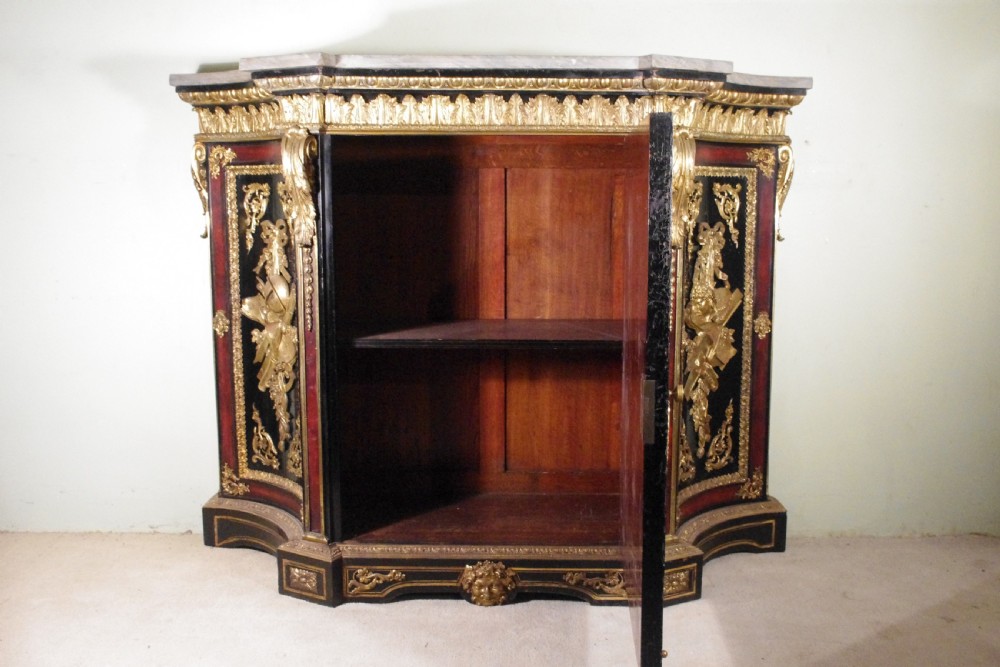 A 19th-century French ebonised side cabinet featuring gilt-metal mounts, a central red panel with a classical medallion, and a contoured marble top. View XXVII